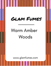A bottle of 'Glam Fumes Warm Amber Woods' perfume with a colorful striped background.